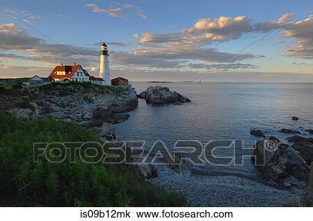 Stock Image - Lighthouse on cliff by ocean, Cape Elizabeth, Portland, Maine, USA. Fotosearch