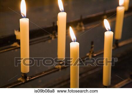 Lit candles on candle holder View Large Photo Image Stock Photo - Lit candles on candle holder. Fotosearch