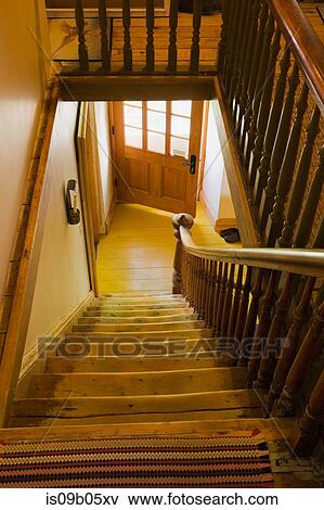 Main staircase leading to the downstairs floor in old (1785) fieldstone cottage style residential home, Quebec, Canada View Large Photo Image Stock Photo - Main staircase leading to the downstairs floor in old (1785) fieldstone cottage style residential home, Quebec, Canada. Fotosearch