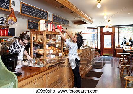 Male and female workers in bakery going about business View Large Photo Image Stock Photography - Male and female workers in bakery going about business. Fotosearch