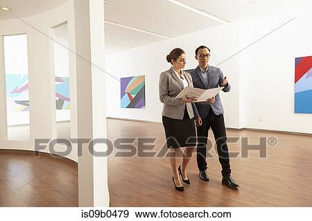 Male asian worker and caucasian female manager in gallery of printing and packaging factory, China View Large Photo Image Stock Photo - Male asian worker and caucasian female manager in gallery of printing and packaging factory, China. Fotosearch