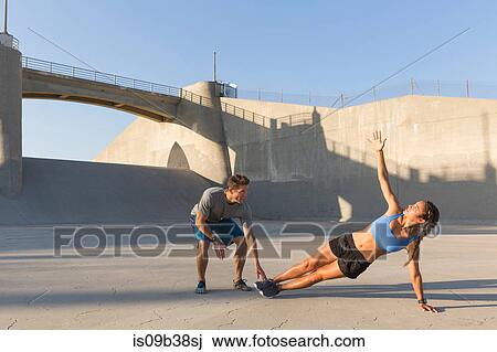 Male athlete helping friend with workout, Van Nuys, California, USA View Large Photo Image Stock Image - Male athlete helping friend with workout, Van Nuys, California, USA. Fotosearch
