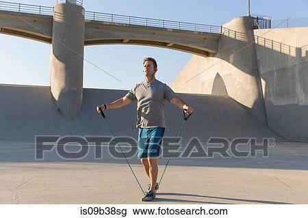 Male athlete stretching with resistance band, Van Nuys, California, USA View Large Photo Image Stock Image - Male athlete stretching with resistance band, Van Nuys, California, USA. Fotosearch