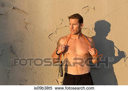 Male athlete with resistance band around neck View Large Photo Image Stock Photography - Male athlete with resistance band around neck. Fotosearch