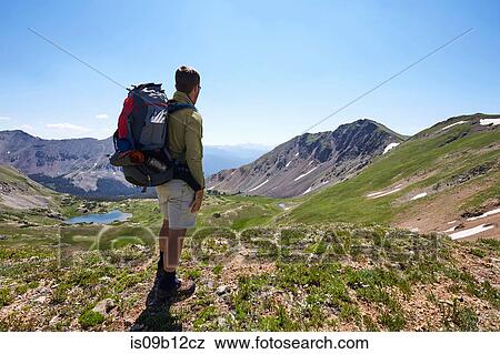Male backpacker looking out at landscape, Never Summer Wilderness, Colorado, USA View Large Photo Image Stock Photo - Male backpacker looking out at landscape, Never Summer Wilderness, Colorado, USA. Fotosearch