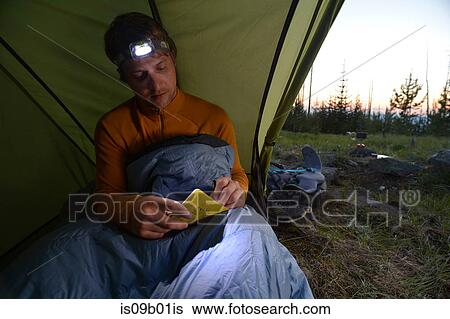 Male camper in sleeping bag writing his journal at dusk on Midnight Ridge, Colville National Forest, Washington State, USA View Large Photo Image Stock Photograph - Male camper in sleeping bag writing his journal at dusk on Midnight Ridge, Colville National Forest, Washington State, USA. Fotosearch