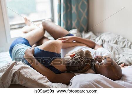 Male couple lying in bed together, hugging, rear view View Large Photo Image Stock Photograph - Male couple lying in bed together, hugging, rear view. Fotosearch