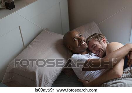 Male couple lying in bed together, hugging View Large Photo Image Stock Photography - Male couple lying in bed together, hugging. Fotosearch