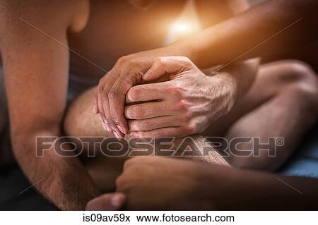Male couple sitting together, holding hands, mid section View Large Photo Image Stock Photo - Male couple sitting together, holding hands, mid section. Fotosearch