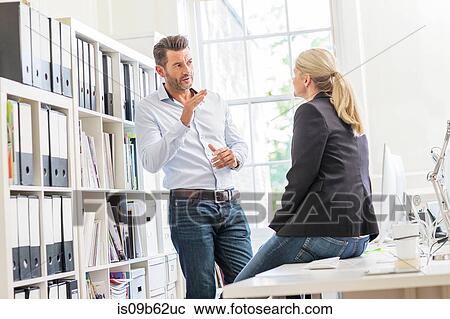 Male designer explaining idea to female colleague in creative studio meeting View Large Photo Image Stock Image - Male designer explaining idea to female colleague in creative studio meeting. Fotosearch