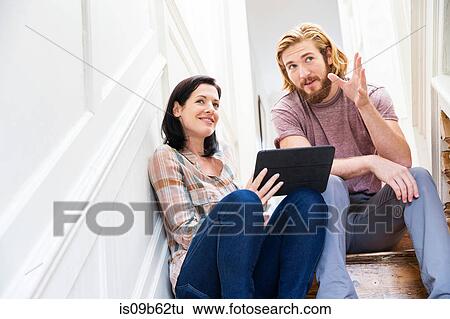 Male designer explaining idea to colleague on creative studio stairway View Large Photo Image Stock Photograph - Male designer explaining idea to colleague on creative studio stairway. Fotosearch