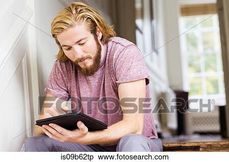 Male designer using digital tablet on creative studio step View Large Photo Image Stock Photography - Male designer using digital tablet on creative studio step. Fotosearch