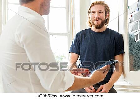 Male designers using digital tablet at creative studio meeting View Large Photo Image Stock Photograph - Male designers using digital tablet at creative studio meeting. Fotosearch