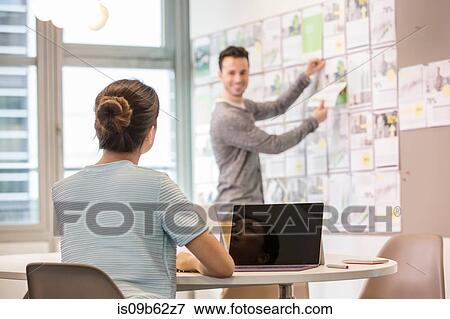 Stock Photo - Male digital designer preparing mood board in office. Fotosearch
