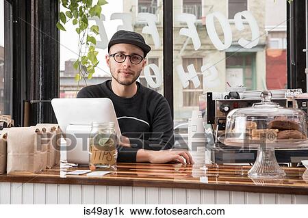 Male employee in cafe, New York, USA View Large Photo Image Stock Image - Male employee in cafe, New York, USA. Fotosearch