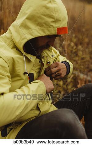 Stock Photo - Male hiker fastening anorak, Mineral King, Sequoia National Park, California, USA. Fotosearch