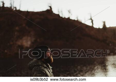 Stock Image - Male hiker gazing near lake, Mineral King, Sequoia National Park, California, USA. Fotosearch