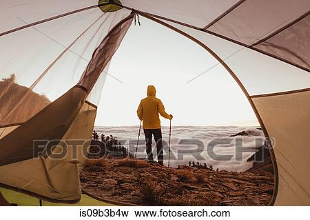 Stock Photo - Male hiker looking out over the clouds, Mineral King, Sequoia National Park, California, USA. Fotosearch