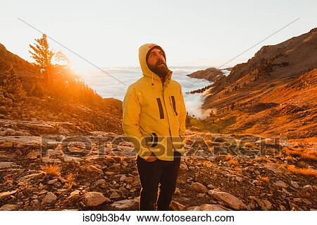 Stock Photo - Male hiker looking up from rocky landscape, Mineral King, Sequoia National Park, California, USA. Fotosearch