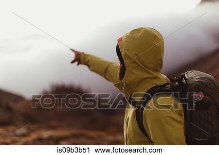 Stock Image - Male hiker pointing out over the clouds, Mineral King, Sequoia National Park, California, USA. Fotosearch