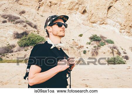 Male hiker wearing baseball cap walking on beach, Crystal Cove State Park, Laguna Beach, California, USA View Large Photo Image Stock Image - Male hiker wearing baseball cap walking on beach, Crystal Cove State Park, Laguna Beach, California, USA. Fotosearch