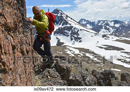 Male mountain climber climbing steep mountain, Chugach State Park, Anchorage, Alaska, USA View Large Photo Image Stock Image - Male mountain climber climbing steep mountain, Chugach State Park, Anchorage, Alaska, USA. Fotosearch