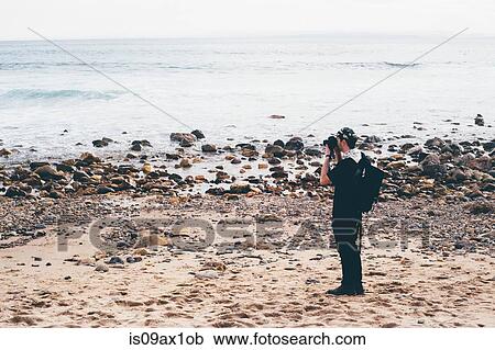Male photographer photographing from beach, Crystal Cove State Park, Laguna Beach, California, USA View Large Photo Image Stock Image - Male photographer photographing from beach, Crystal Cove State Park, Laguna Beach, California, USA. Fotosearch