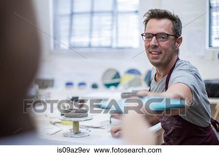 Male potter handing digital tablet in workshop View Large Photo Image Stock Photo - Male potter handing digital tablet in workshop. Fotosearch