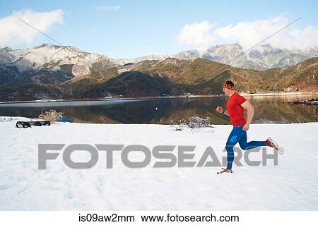 Male runner running along snow covered lakeside, Lake Kawaguchiko, Mount Fuji, Japan View Large Photo Image Picture - Male runner running along snow covered lakeside, Lake Kawaguchiko, Mount Fuji, Japan. Fotosearch