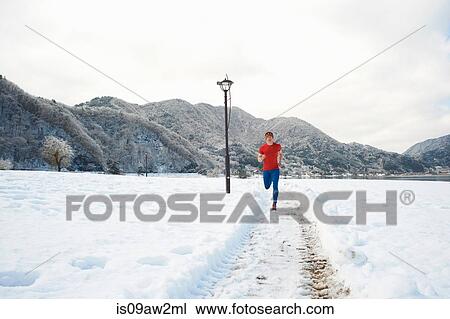 Male runner running along snow covered tracks, Lake Kawaguchiko, Mount Fuji, Japan View Large Photo Image Stock Image - Male runner running along snow covered tracks, Lake Kawaguchiko, Mount Fuji, Japan. Fotosearch