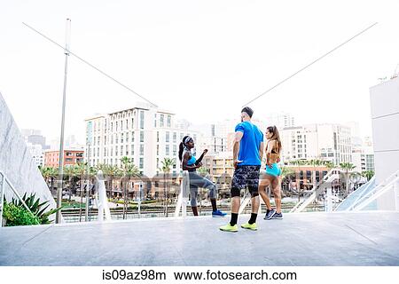Man and two young women training, chatting on stairway at sport facility, downtown San Diego, California, USA View Large Photo Image Picture - Man and two young women training, chatting on stairway at sport facility, downtown San Diego, California, USA. Fotosearch