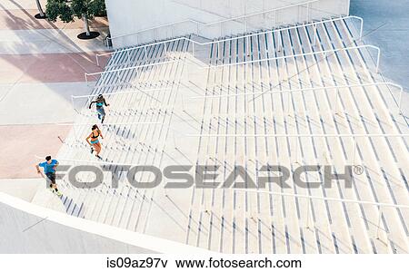 Man and two young women training, running up sport facility stairway, downtown San Diego, California, USA View Large Photo Image Stock Photo - Man and two young women training, running up sport facility stairway, downtown San Diego, California, USA. Fotosearch