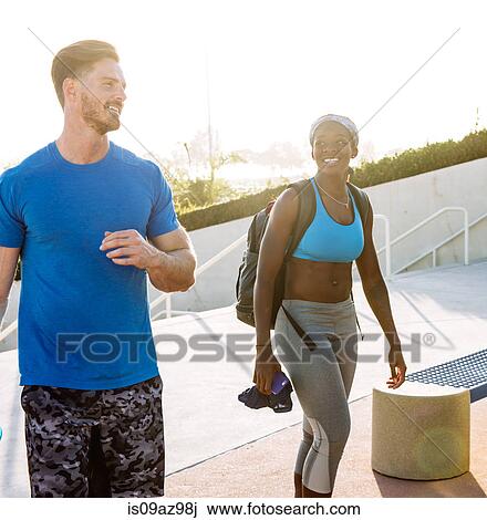 Stock Image - Man and woman training, chatting at sport facility, downtown San Diego, California, USA. Fotosearch