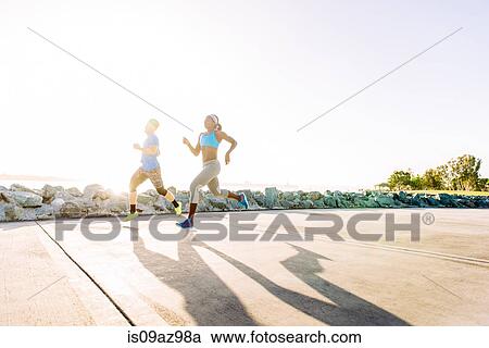 Man and young woman training, running on sunlit coast, downtown San Diego, California, USA View Large Photo Image Stock Image - Man and young woman training, running on sunlit coast, downtown San Diego, California, USA. Fotosearch