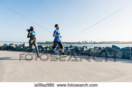 Man and young woman training, running on coast, downtown San Diego, California, USA View Large Photo Image Stock Photography - Man and young woman training, running on coast, downtown San Diego, California, USA. Fotosearch