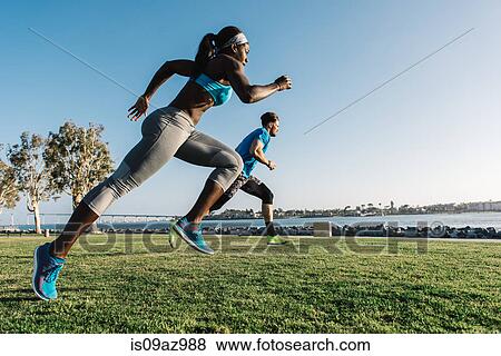 Man and young woman training, sprinting on coast, downtown San Diego, California, USA View Large Photo Image Stock Photo - Man and young woman training, sprinting on coast, downtown San Diego, California, USA. Fotosearch