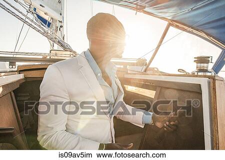 Man at cabin of sailboat View Large Photo Image Picture - Man at cabin of sailboat. Fotosearch