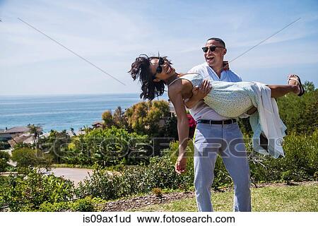 Man carrying woman on hill near ocean, Los Angeles, California View Large Photo Image Stock Image - Man carrying woman on hill near ocean, Los Angeles, California. Fotosearch
