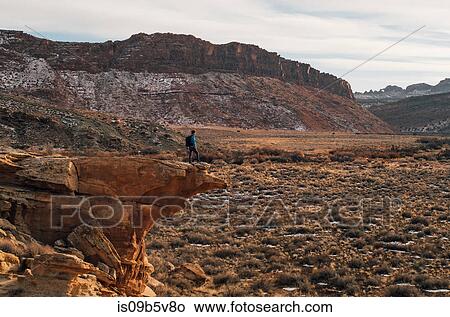 Man hiking across desert, Moab, Utah, USA View Large Photo Image Picture - Man hiking across desert, Moab, Utah, USA. Fotosearch