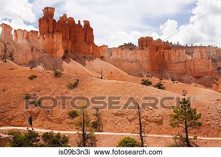 Man hiking along pathway, Bryce Canyon National Park, Utah, USA View Large Photo Image Stock Image - Man hiking along pathway, Bryce Canyon National Park, Utah, USA. Fotosearch