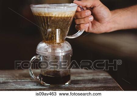 Stock Image - Man holding filter coffee maker. Fotosearch