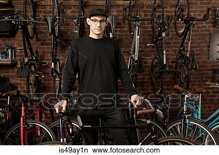 Man in bicycle shop View Large Photo Image Picture - Man in bicycle shop. Fotosearch