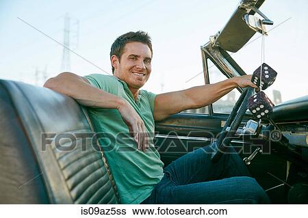 Man in convertible car looking at camera smiling, Los Angeles, California, USA View Large Photo Image Stock Photograph - Man in convertible car looking at camera smiling, Los Angeles, California, USA. Fotosearch