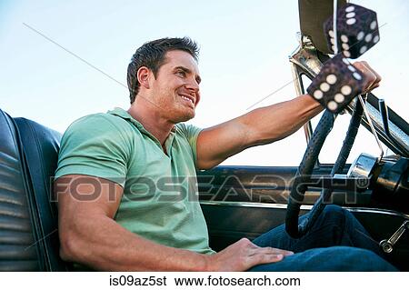 Man in convertible car looking away smiling, Los Angeles, California, USA View Large Photo Image Stock Photograph - Man in convertible car looking away smiling, Los Angeles, California, USA. Fotosearch