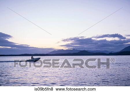 Man in speedboat on water, Pacific Rim National Park, Vancouver Island, Canada View Large Photo Image Stock Photo - Man in speedboat on water, Pacific Rim National Park, Vancouver Island, Canada. Fotosearch