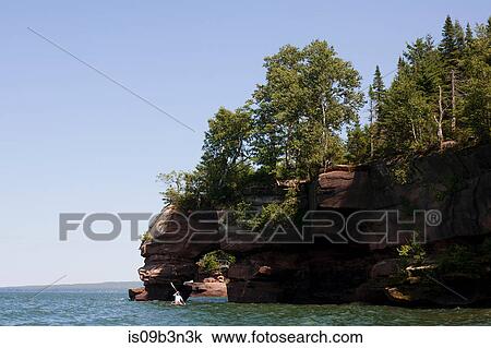 Stock Image - Man kayaking on Lake Superior, Apostle Islands National Lakeshore, Wisconsin, USA. Fotosearch