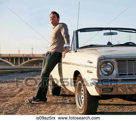 Man leaning against convertible classic car, Los Angeles, California, USA View Large Photo Image Stock Photo - Man leaning against convertible classic car, Los Angeles, California, USA. Fotosearch