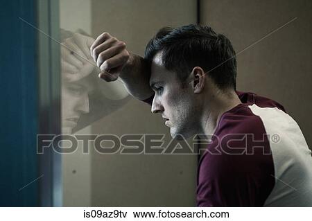 Man leaning against window looking out View Large Photo Image Stock Photo - Man leaning against window looking out. Fotosearch