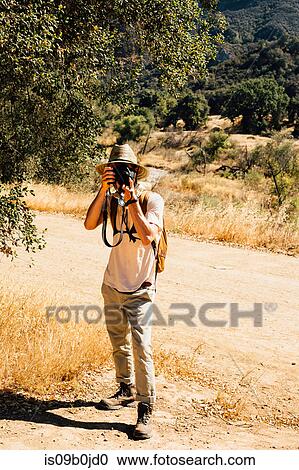 Man looking at camera, photographing, Malibu Canyon, California, USA View Large Photo Image Stock Image - Man looking at camera, photographing, Malibu Canyon, California, USA. Fotosearch