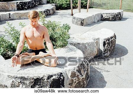 Man meditating in lotus pose on park stone seat View Large Photo Image Stock Image - Man meditating in lotus pose on park stone seat. Fotosearch